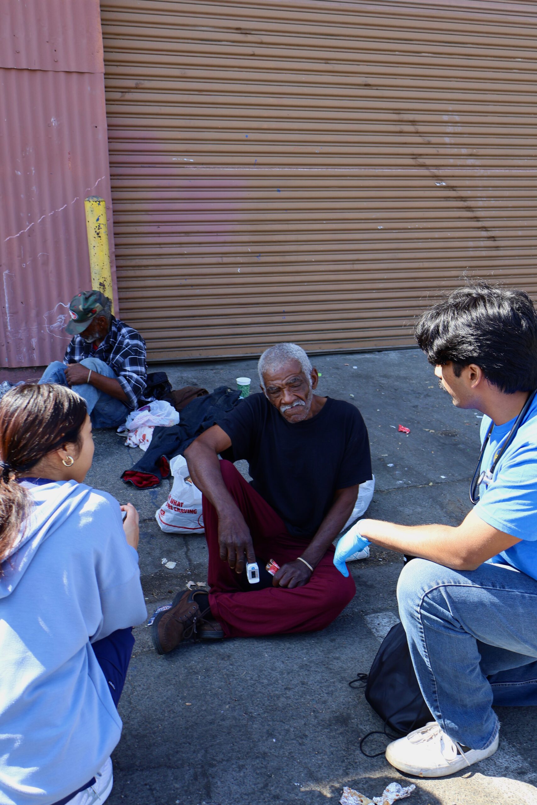 Valliant Foundation volunteers speaking with a community member during outreach