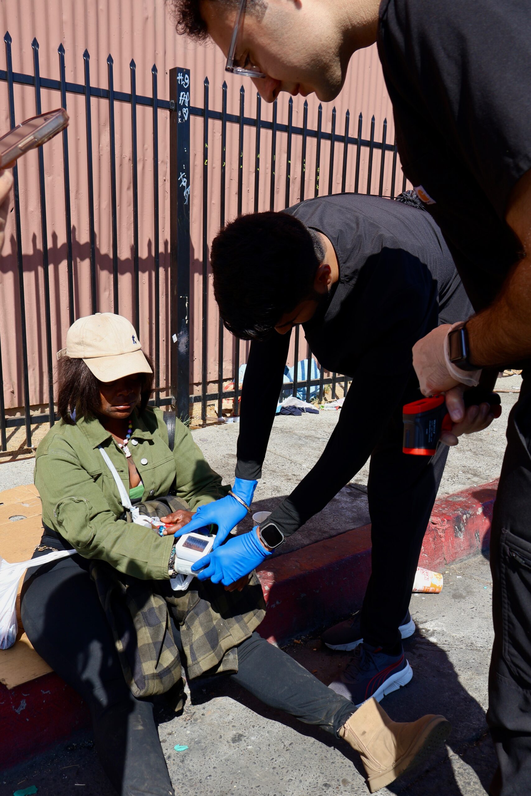 Valliant Foundation volunteer helping an unsheltered woman with a blood pressure screening